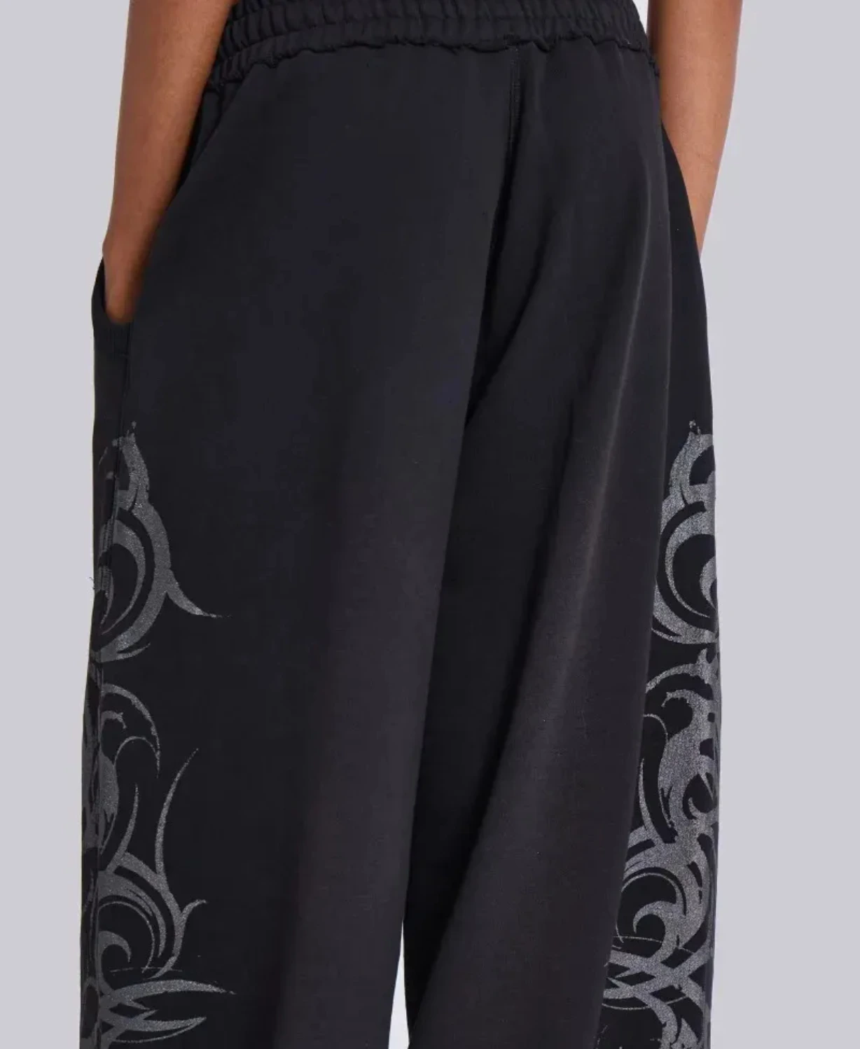 Black wide-leg sweatpants with black tribal graphic print