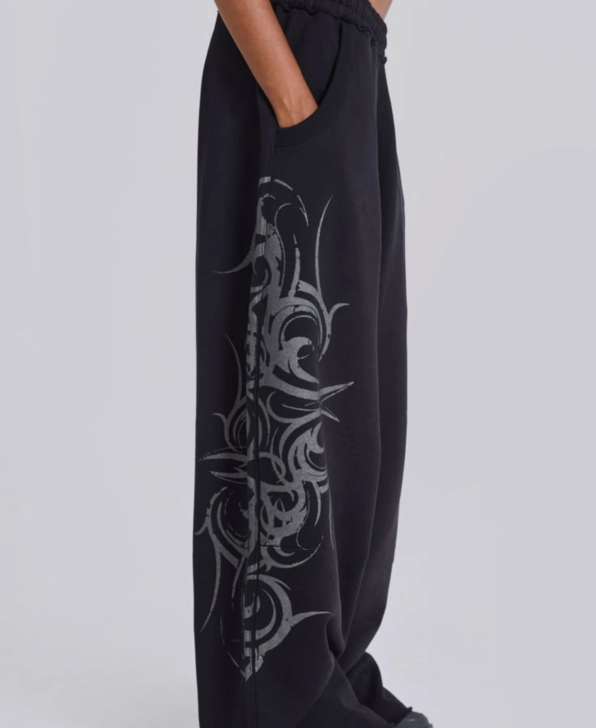 Black wide-leg sweatpants with black tribal graphic print