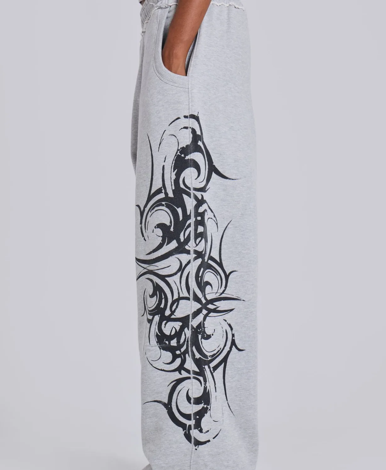 Grey wide-leg sweatpants with black tribal graphic print
